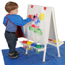 Toddler painting at easel